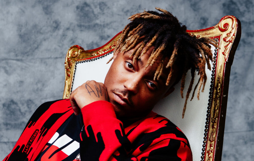 Juice WRLD performing under dim stage lights, symbolizing emotional struggle and fading hope